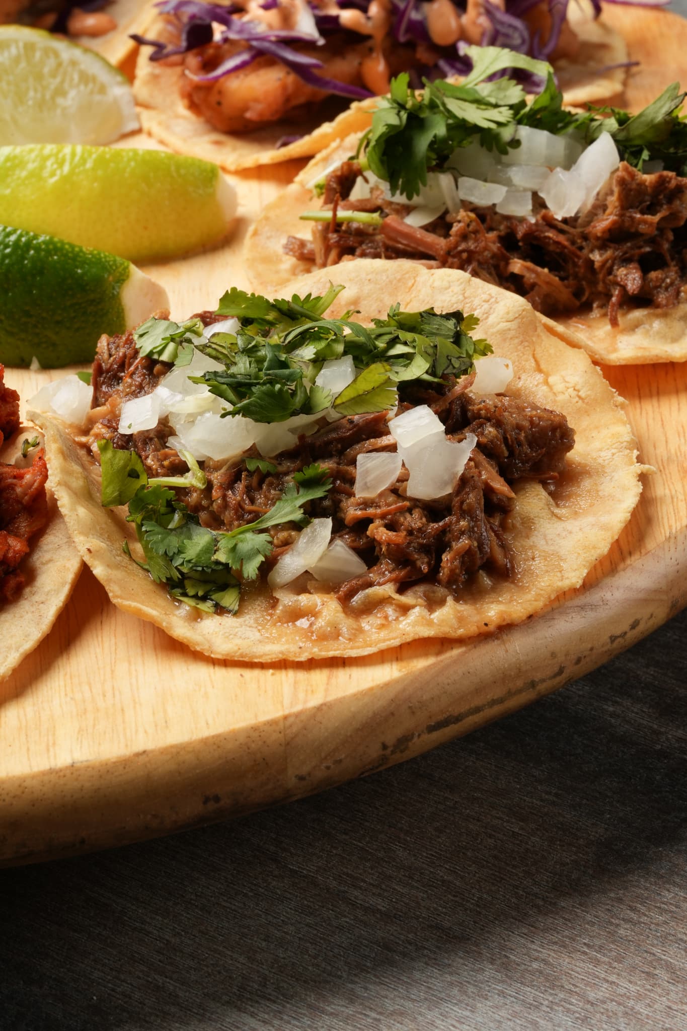 Close-up of a street taco topped with fresh cilantro and onion at Tiempo D' Tacos in Miami